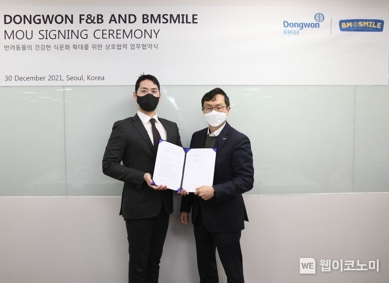 이상진 동원F&B 전략사업부장(오른쪽)과 모성현 비엠스마일 한국 대표(왼쪽)가 지난달 30일 비엠스마일 본사에서 업무 협약을 맺고 기념 사진 촬영을 하고 있다2022.01.03. 출처: 동원F&B