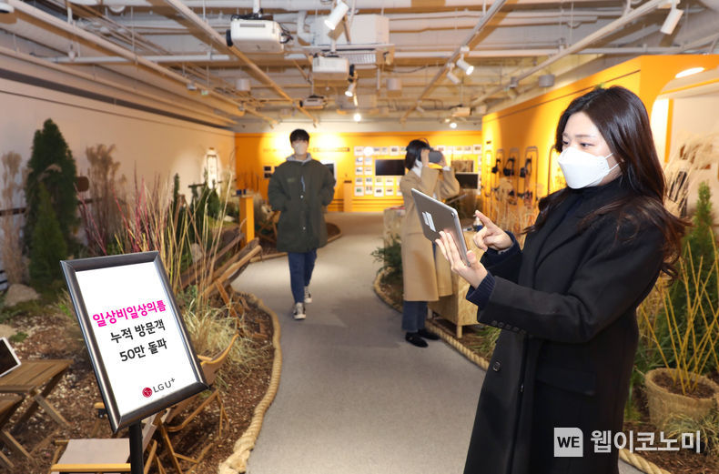  사진은 LG유플러스 모델이 ‘로컬트레인’ 전시가 진행 중인 일상비일상의틈 지하 1층에서 누적 방문객 50만 돌파를 소개하는 모습. 2022.01.21 (출처: LG유플러스)