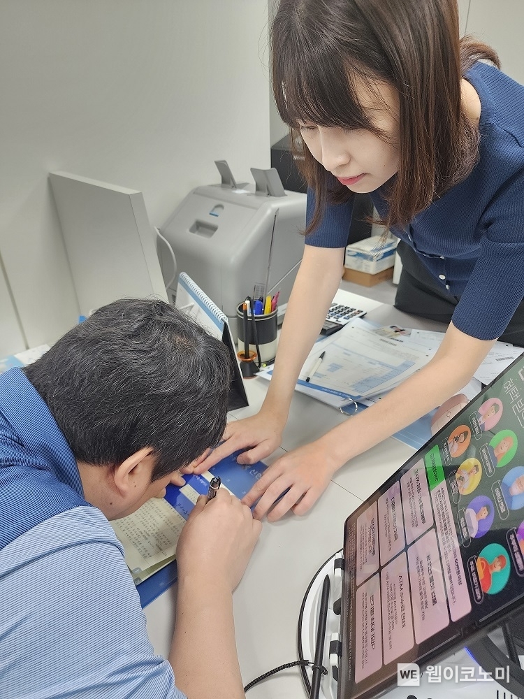 서울시 소재 신한은행 영업점에서 직원이 ‘마음맞춤 응대 KIT’를 활용해 시각장애인 고객과 업무를 진행하는 모습 / 2024.04.17 (출처: 신한은행)