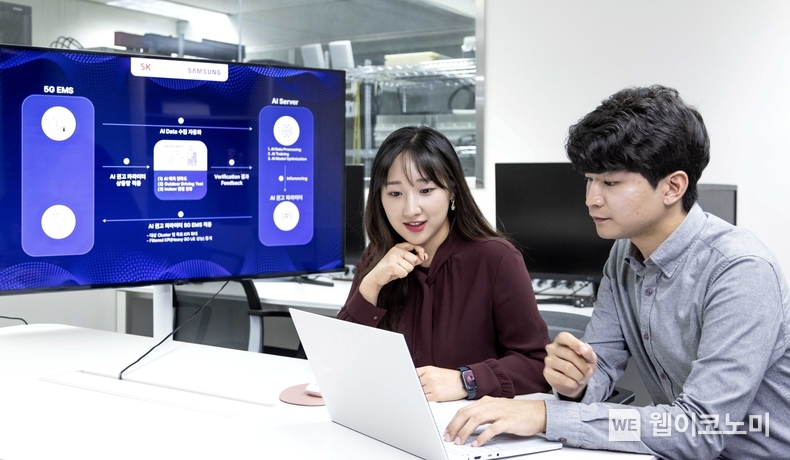 SK텔레콤과 삼성전자 연구원이 AI 기반 5G 기지국 품질 최적화 기술 실증에 대해 논의하는 모습. / 2024.10.28 (출처: SK텔레콤)